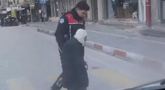Yolun karşısına geçmekte zorlanan yaşlı kişiye polis yardım etti
